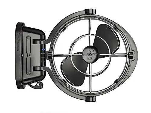 SEEKR Sirocco II 12V fan mounted on a wall in a camper van, showing its gimbaled head.