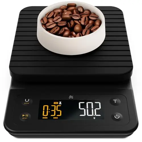 Greater Goods black coffee scale with a silicone mat on a wooden table.