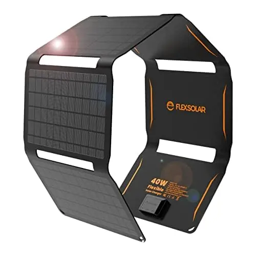 FlexSolar 40W large solar panel fully unfolded on a grassy field, with a power bank charging