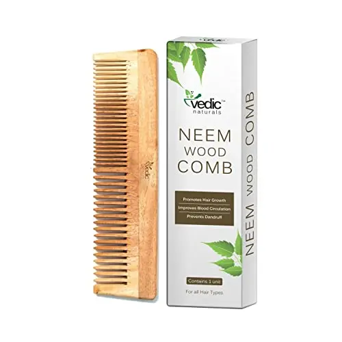VEDIC NATURALS 100% Pure Neem Wood Comb with wide and thin teeth, shown on a wooden background.