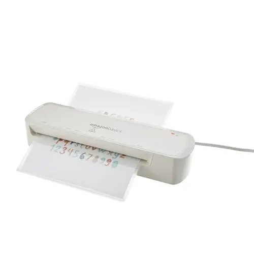 White Amazon Basics 9-inch thermal laminator machine on a desk.
