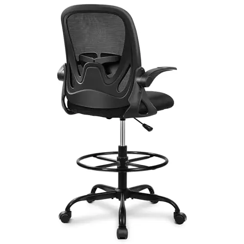 Primy black ergonomic drafting chair with mesh back, flip-up arms, and a footrest ring