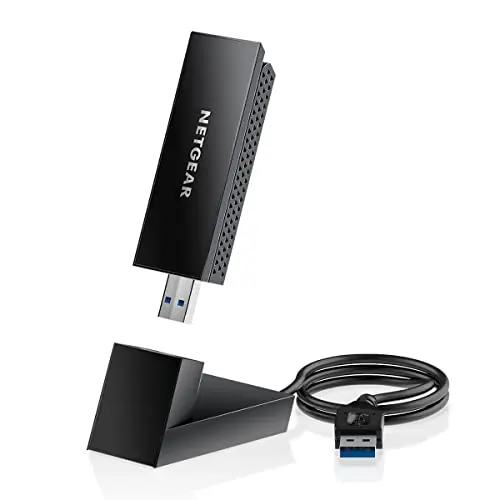 NETGEAR Nighthawk A8000 WiFi 6E USB adapter with compact cradle and flippable antenna.