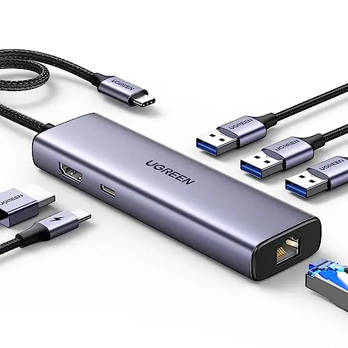 UGREEN Revodok 6-in-1 USB C hub in grey, showcasing its slim profile and ports including HDMI and Ethernet.