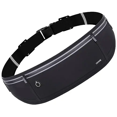 USHAKE slim running belt worn around the waist during a walk, showing its reflective strips and zippered pockets.