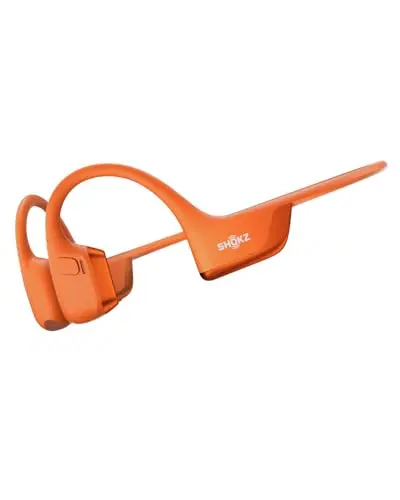 SHOKZ OpenRun Pro 2 bone conduction headphones in orange, wrapped around a rider's helmet strap.