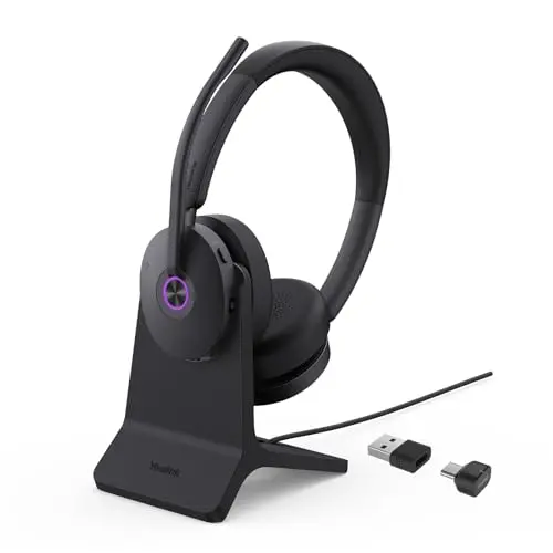 Yealink BH74 wireless headset with charging stand on a desk